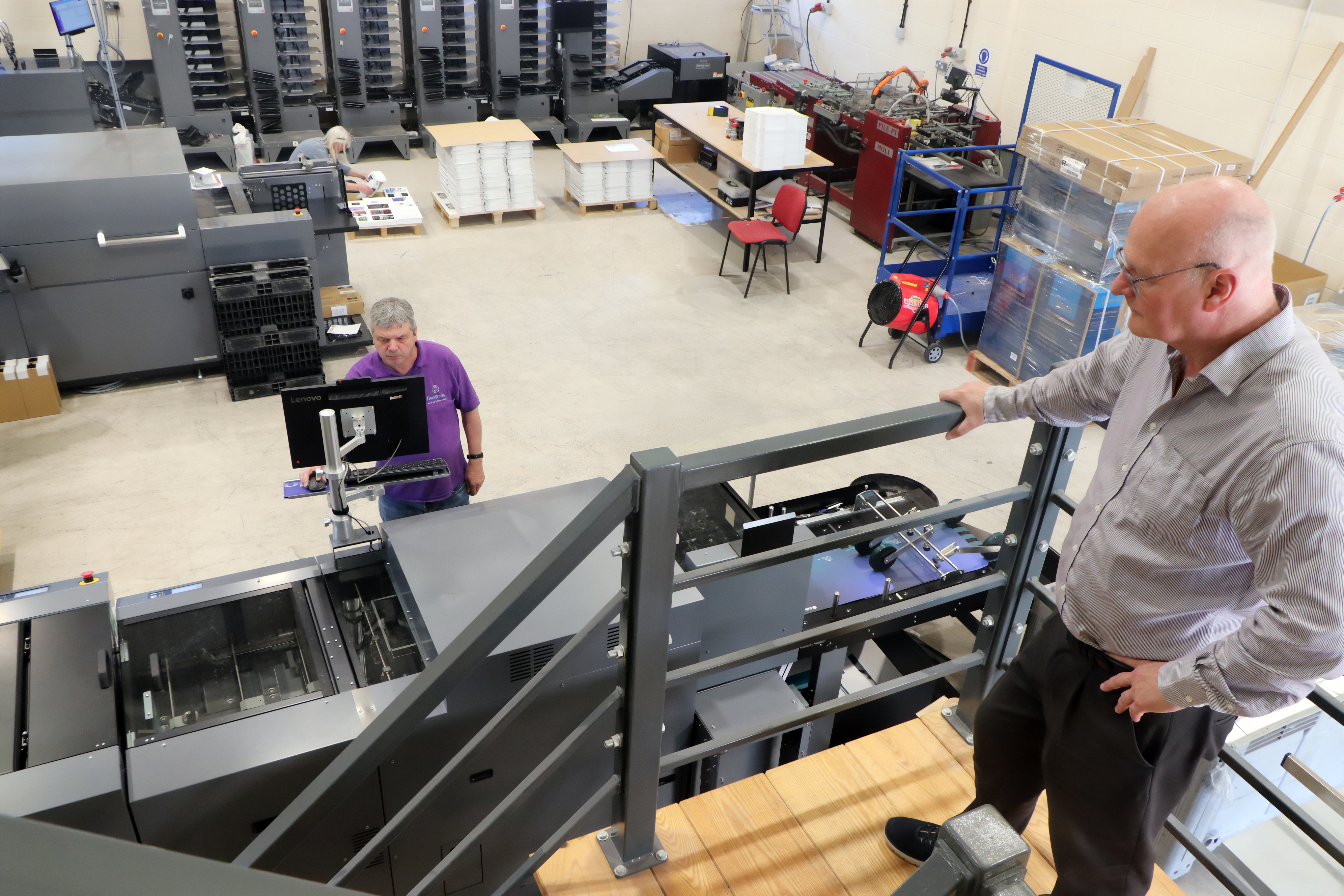 Steve overlooking his DSM-1000 B2 die cutter, DDC-8000 B2 DuSense, DC-20K B2 finishing system and his DBM-700 automatic booklet system.