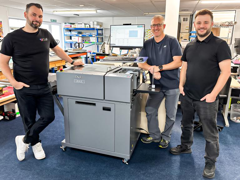 (Left to right) Chairman Brad Bray, Production Manager Steve Enright, and Director John Pike, with Lola Design, Print Web’s new Duplo DC-618 multi finisher.