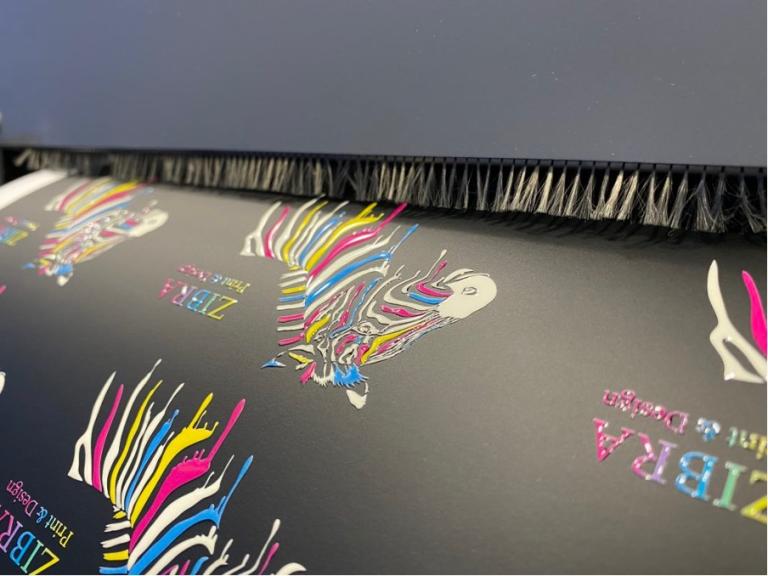 The left image shows the misalignment of the spot layer, while the right image illustrates how the spot layer aligns correctly with the printed image.